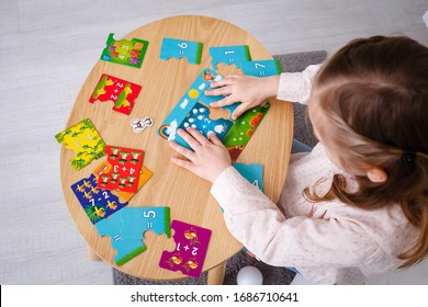 Girl Solve Math Examples On The Table Game 