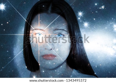 A girl with a soulful look against the background of a starry sky. Sparkling look. The concept of paranormal abilities, clairvoyance, mysticism. Elements of this image furnished by NASA