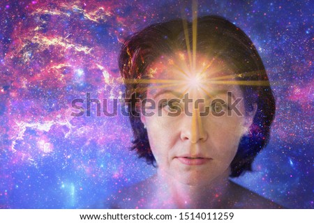 girl with soulful look against background of starry sky. on forehead of girl glowing star symbol of open mind. paranormal abilities, clairvoyance, mysticism. Elements of this image furnished by NASA 