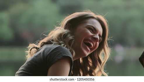 Girl Speaking To Friend In Conversation, Burts Laughing Out Loud To Friend Joke. Real Life Authentic Smile And Spontaneous Laugh