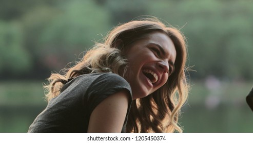 Girl Speaking To Friend In Conversation, Burts Laughing Out Loud To Friend Joke. Real Life Authentic Smile And Spontaneous Laugh