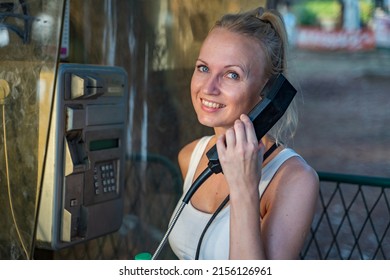 A girl speaking in a telephone booth