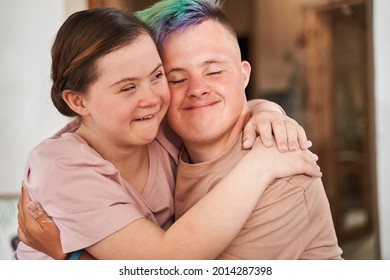 Girl with special needs embracing tight her boyfriend with colored hair - Powered by Shutterstock