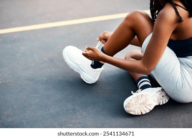 Girl, sport and tying laces on basketball court or park for challenge, training or workout as athlete. Female person, shoes and outdoor for competition, match or game as physical activity or exercise - Powered by Shutterstock