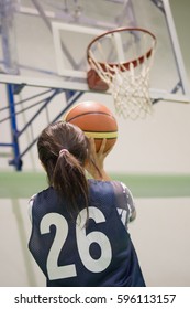 Girl In Sport Uniform Playing Basketball