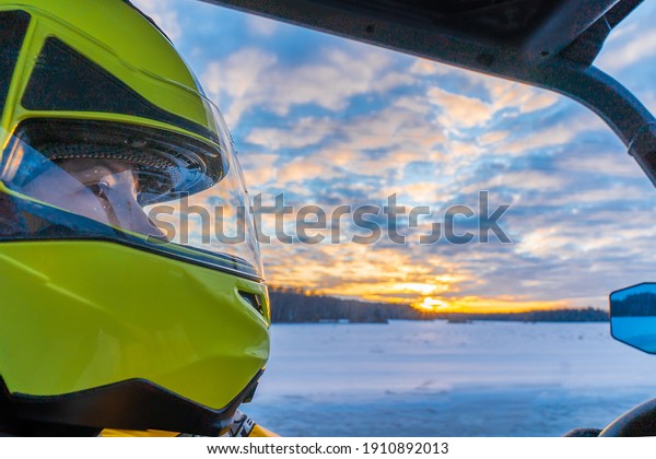 girl in a sports yellow helmet in the car on the\
background of sunset