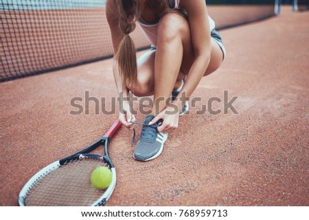 Similar – Young woman stretching legs before training outdoors