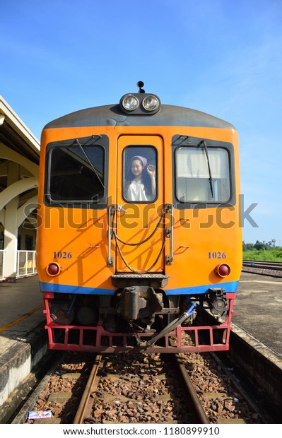 Girl stand inside the train room front of\
train, and smile. In Thanalaeng station,Hardxaiyfong\
district,Vientiane capital,Laos. in 17 Sep\
2018.