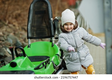 Girl Stand Near Electric Sleigh Ride On Rails. 