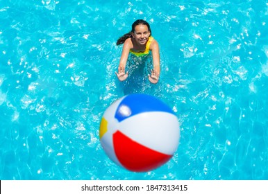 Girl Stand In Swimming Pool Throw Inflatable Ball View From Above