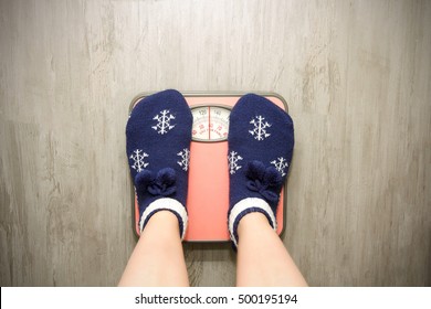 
girl standing on floor vysah in Christmas socks