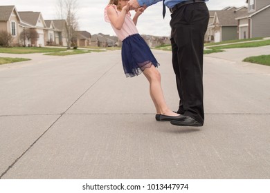 Girl Standing On Man's Feet Dancing In The Street