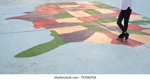 A Girl Standing On A Map Of The United States Marking North Carolina.  