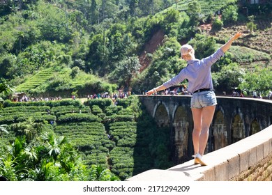 Girl standing on the Nine arch bridge in Sri Lanka. It's a very beautiful historical bridge. Back view of a girl.