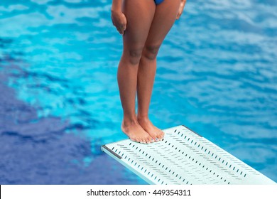 Girl Standing On A Springboard, Preparing To Dive