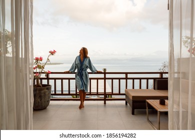 The Girl Is Standing On A Terraced House By The Sea, Enjoy Morning Fresha Air With Ocean View