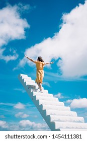 A girl standing on a white heavenly staircase extends into blue sky  Dalat, Vietnam.