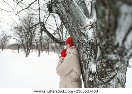 Foto Bild Ein Mann in winterbekleidung spielt Elefant und formt seine Arme zu einem Rüssel. Winter. Humor