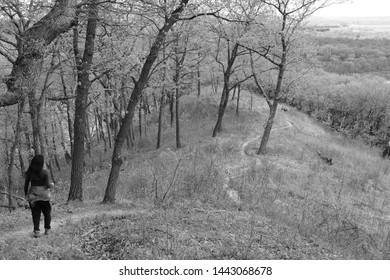 Girl Staring Down Winding Path Atop Hill In Dane County, Wisconsin In Black And White
