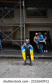 Girl statue in front of NYSE with flag of Ukraine during protest May 4th 2022