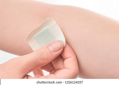 The Girl Sticks A Patch On The Elbow After Giving Blood From A Vein. Concept For Hospitals, Laboratories, Donation Support