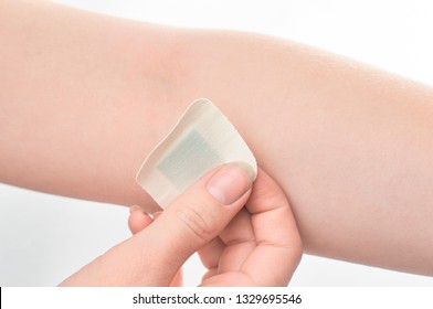 The Girl Sticks A Patch On The Elbow After Giving Blood From A Vein. Concept For Hospitals, Laboratories, Donation Support