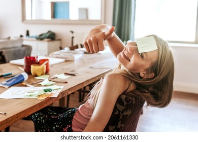 Girl with sticky note on forehead, homeschooling in the new normal - Powered by Shutterstock