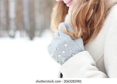 A Girl Straightens Her Hair With Her Hand On The Street In Winter