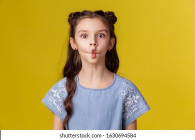 Girl Strange Emotion Fish Lips. Fooling Around Grimace. The Comic Face Is Silly. Child Childhood Schoolgirl. Yellow Copyspace Background Place For Text