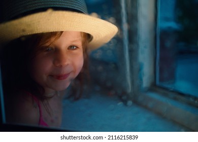 A Girl In A Straw Hat, Rain Outside The Window. High Quality Photo