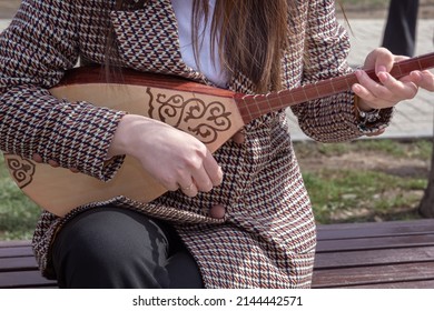 Girl Street Musician Plays The Musical Instrument Dombra