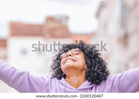 girl in the street outdoors with expression of happiness and joy