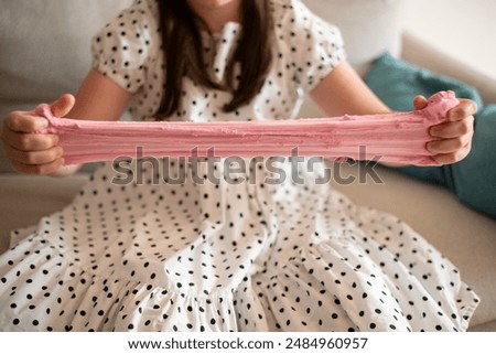 Girl Stretching Slime. Girl Playing with Pink Slime