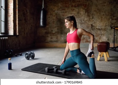 Girl stretching or yoga in gym.Young woman work outing or pilates. Regular sports boosts immune system and promote good health and resistance to diseases. Healthy lifestyle - Shutterstock ID 1790169845