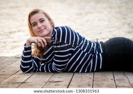 Similar – Young woman sits at the Baltic Sea beach