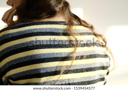 girl in a striped sweater posing for a magazine