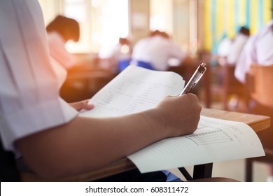 Girl student reading and writing exam with stress.