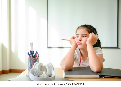 girl student Sitting in the classroom feeling bored with online learning. don't like online education A young female student is sad and tired of not going to school with her friends. - Powered by Shutterstock