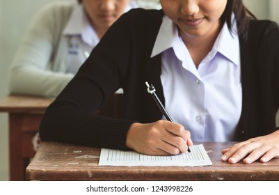 Girl Student Smiling And Writing Exam