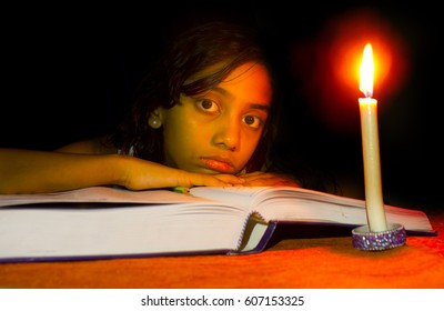 Girl Studying  In Candlelight- No Electricity, Blackout 