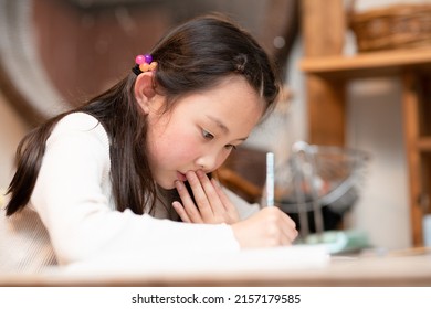 A Girl Studying Hard At Home