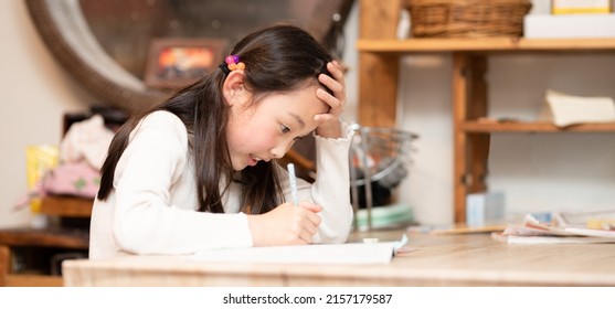 A Girl Studying Hard At Home