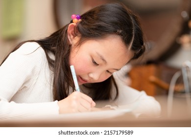 A Girl Studying Hard At Home