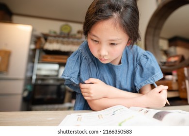 A Girl Studying Hard At Home