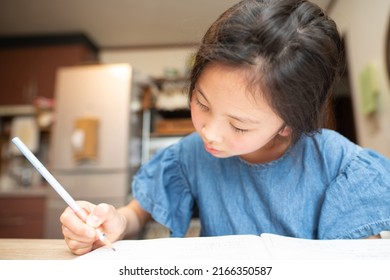 A Girl Studying Hard At Home