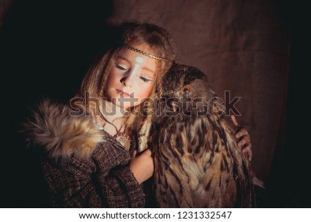 Girl in the style of boho with an owl. Boho chic hugs big owl
