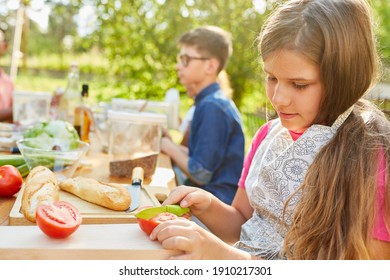 Girl In Summer Camp Vegetarian Diet Cooking Class Cuts A Tomato