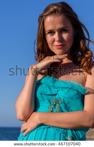 The girl in a summer dress on the beach