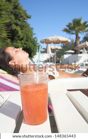 girl sunbathing with cocktail