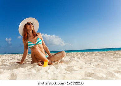 Girl Sunbathing On White Sand Beach